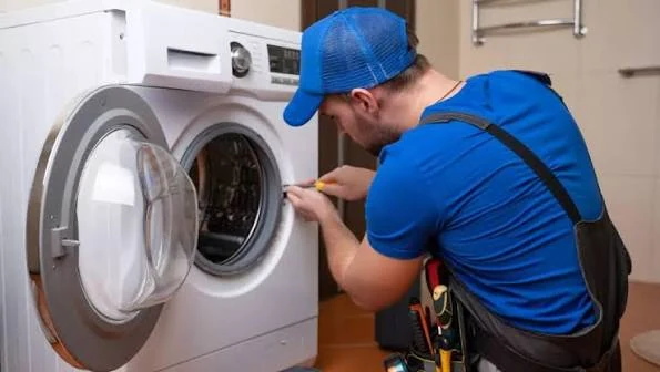 Technician inspecting the door and drum of a front-loading washer